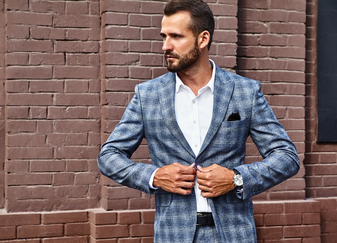 man in a stylish blue and gray checkered blazer
